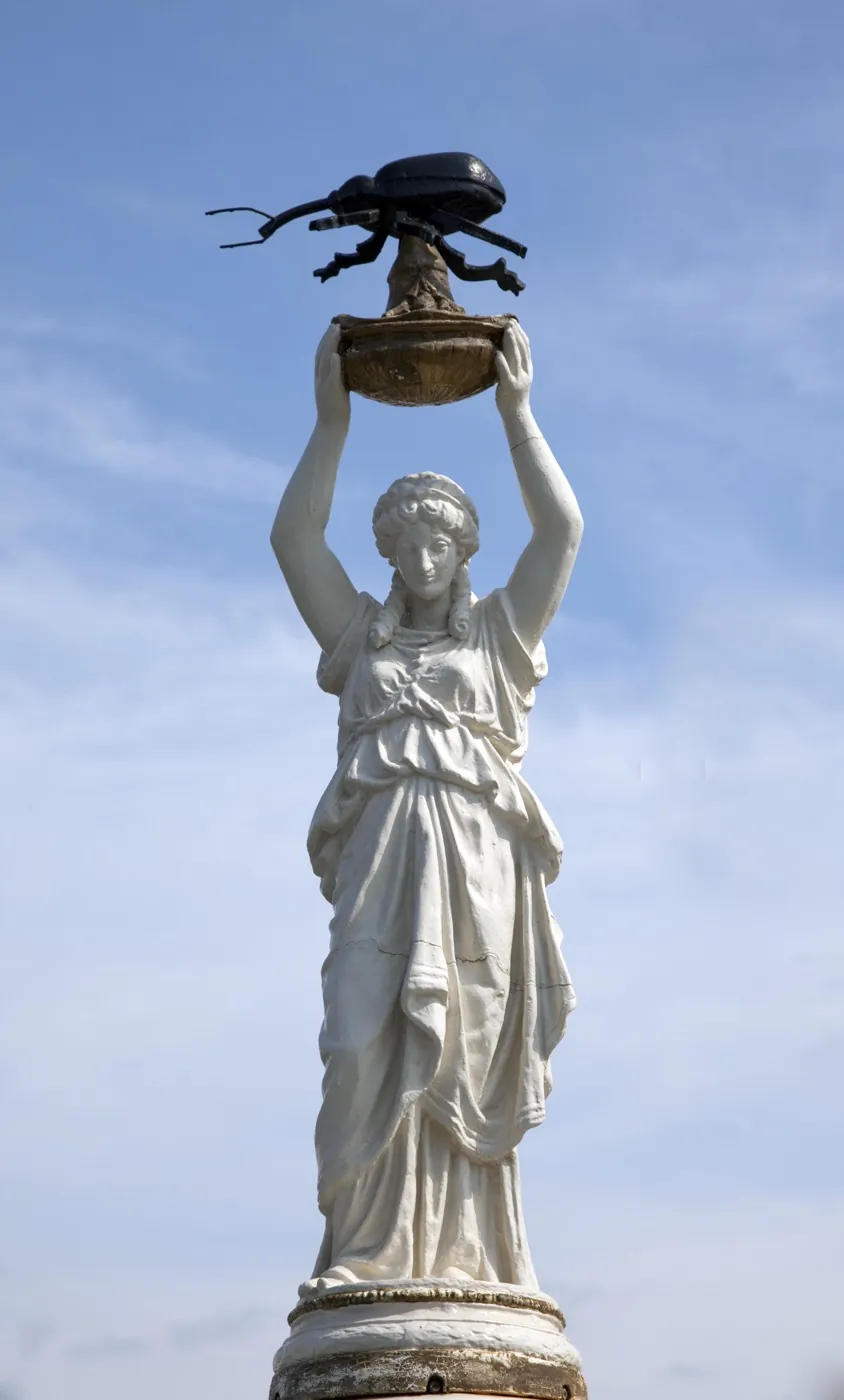 The Boll Weevil Monument against a bright sky